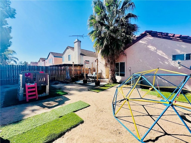 exterior space with a patio and a playground