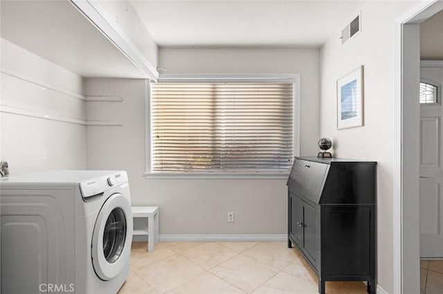 laundry room featuring washer / clothes dryer and light tile patterned floors