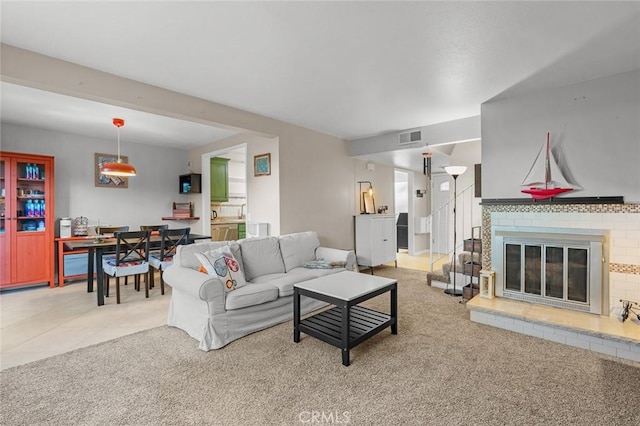 carpeted living room featuring a brick fireplace