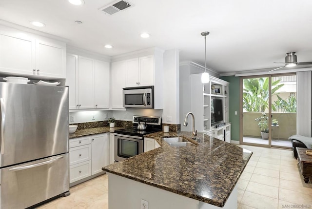 kitchen featuring stainless steel appliances, ceiling fan, sink, decorative light fixtures, and white cabinetry