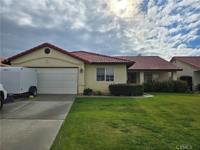 mediterranean / spanish home with a front yard and a garage