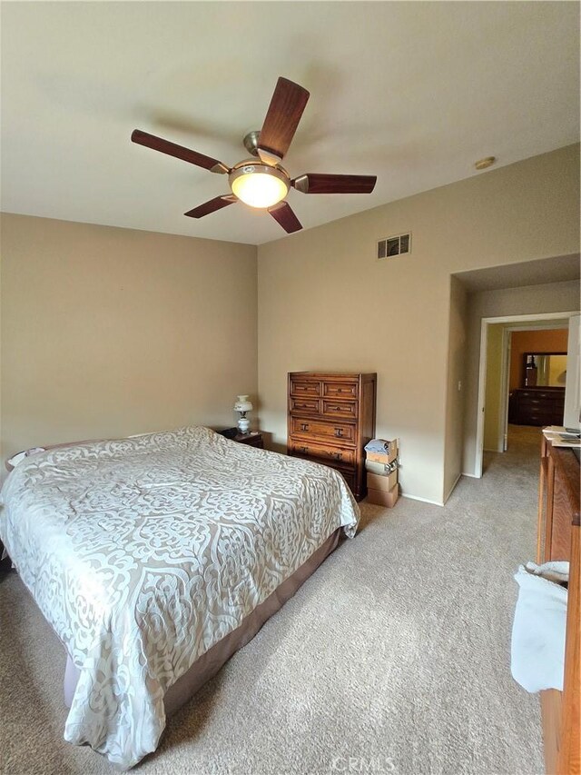 bedroom featuring ceiling fan and light carpet