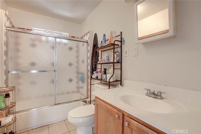 full bathroom featuring toilet, tile patterned flooring, vanity, and combined bath / shower with glass door