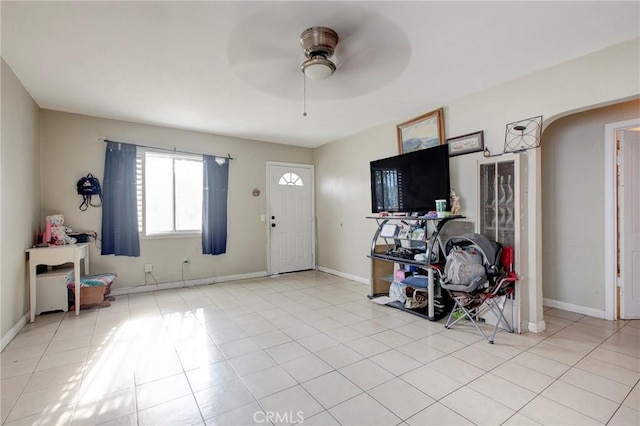 foyer entrance featuring light tile patterned floors and ceiling fan