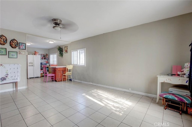 dining space with ceiling fan and light tile patterned flooring