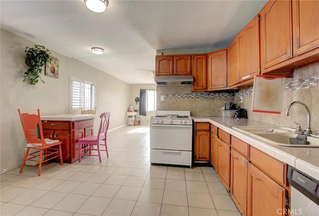 kitchen with white gas range, sink, decorative backsplash, tile countertops, and dishwashing machine