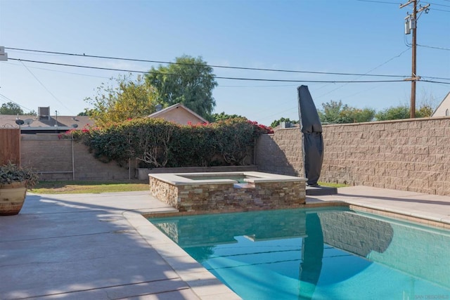 view of swimming pool featuring a jacuzzi and a patio