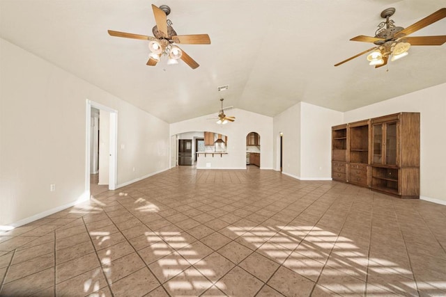 unfurnished living room with tile patterned flooring and vaulted ceiling