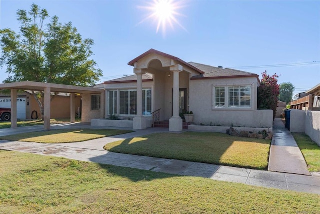 view of front of home with a front lawn and a carport