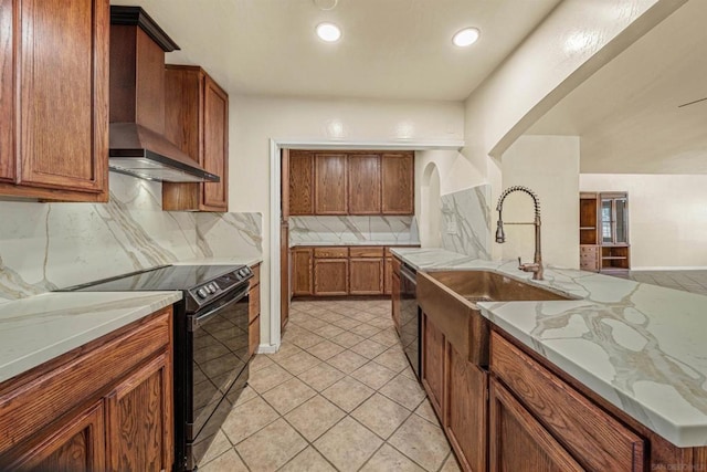 kitchen featuring tasteful backsplash, wall chimney exhaust hood, sink, dishwasher, and black range with electric stovetop