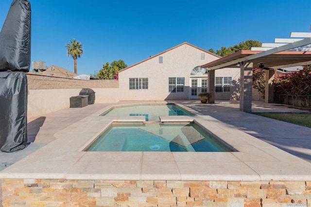 view of pool featuring an in ground hot tub and a patio