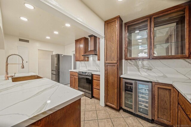 kitchen featuring sink, wall chimney exhaust hood, stainless steel appliances, beverage cooler, and decorative backsplash