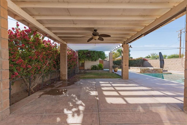 view of patio with ceiling fan and a fenced in pool