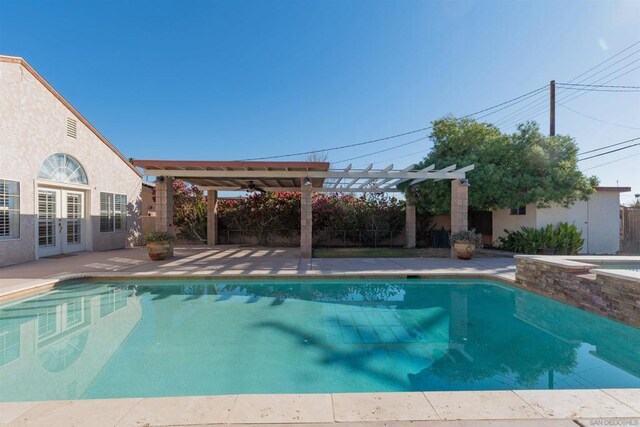 view of swimming pool featuring a pergola and a patio