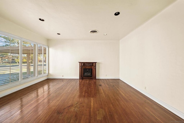 unfurnished living room featuring dark wood-type flooring