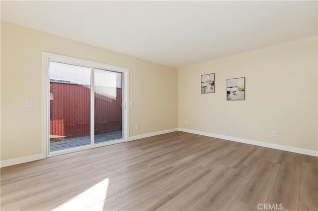 empty room with light hardwood / wood-style flooring