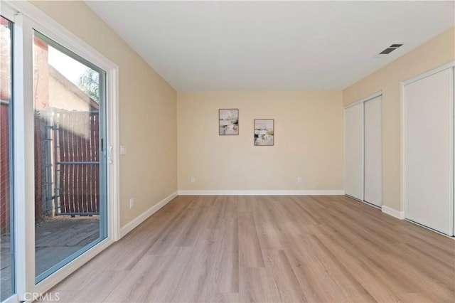 spare room with light hardwood / wood-style floors