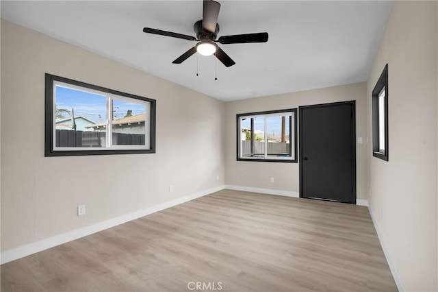 spare room with light wood-type flooring and ceiling fan