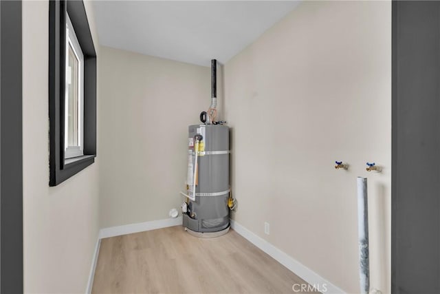 utility room featuring water heater