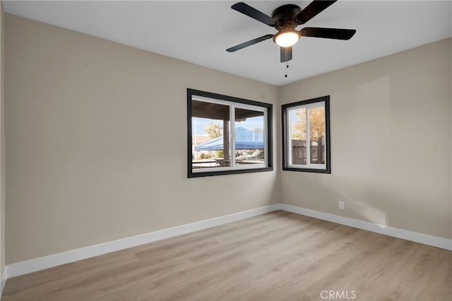 unfurnished room with light wood-type flooring and ceiling fan