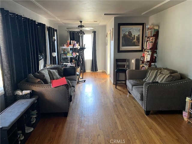 living room with hardwood / wood-style flooring and ceiling fan