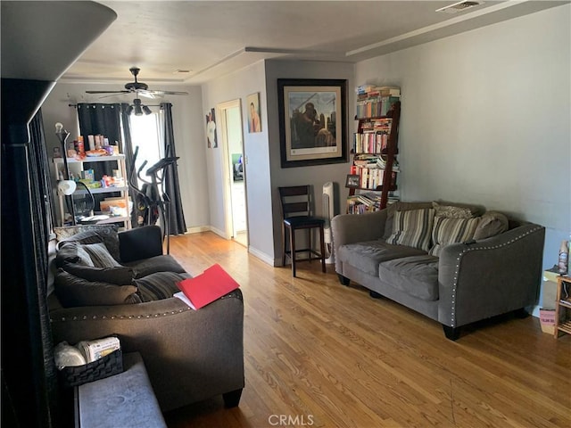 living room with hardwood / wood-style flooring and ceiling fan