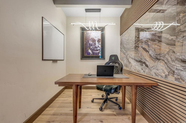 home office with light hardwood / wood-style floors