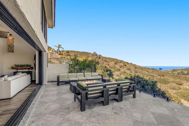 view of patio / terrace with a water view and outdoor lounge area