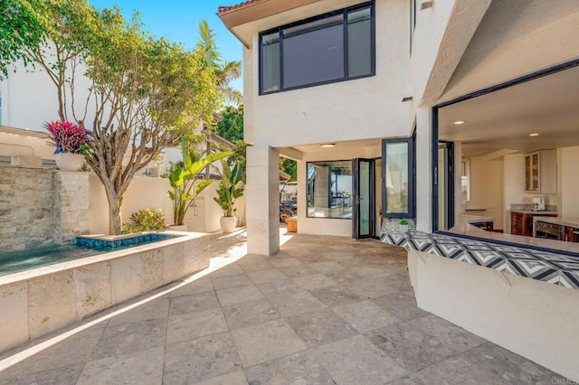 view of patio / terrace featuring a hot tub