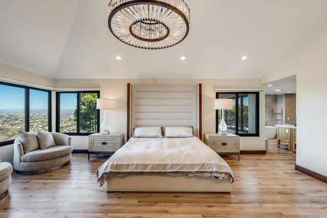 bedroom featuring light wood-type flooring, high vaulted ceiling, and an inviting chandelier