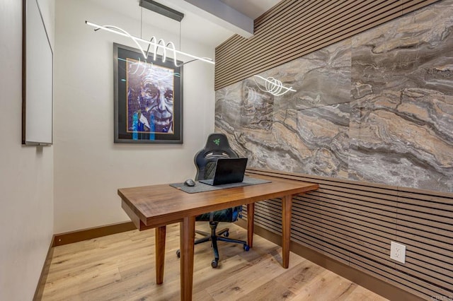 home office with beamed ceiling and light hardwood / wood-style floors