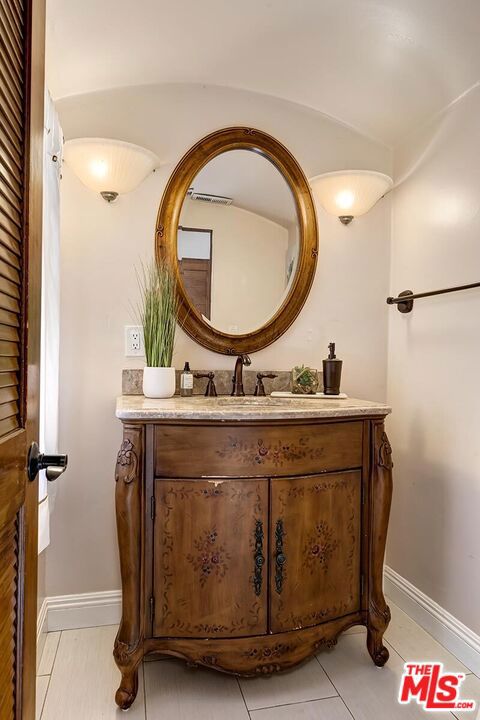 bathroom featuring tile patterned floors and vanity