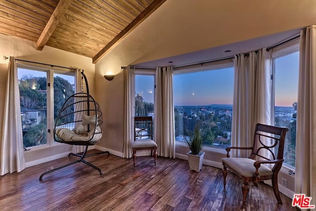 sitting room featuring wooden ceiling, wood-type flooring, and vaulted ceiling with beams