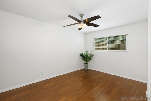 spare room with ceiling fan and dark hardwood / wood-style floors