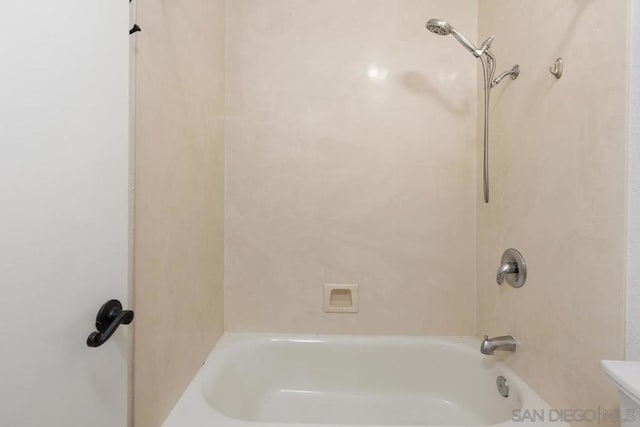 bathroom with tub / shower combination and toilet