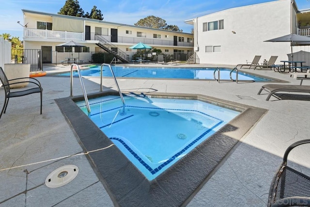 view of pool featuring a patio area and a community hot tub