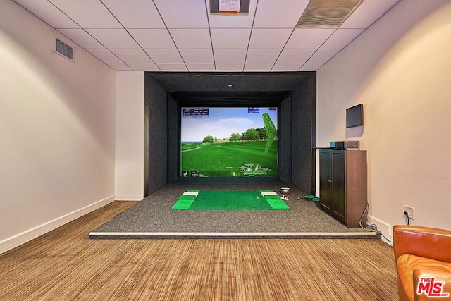 rec room with a paneled ceiling and golf simulator