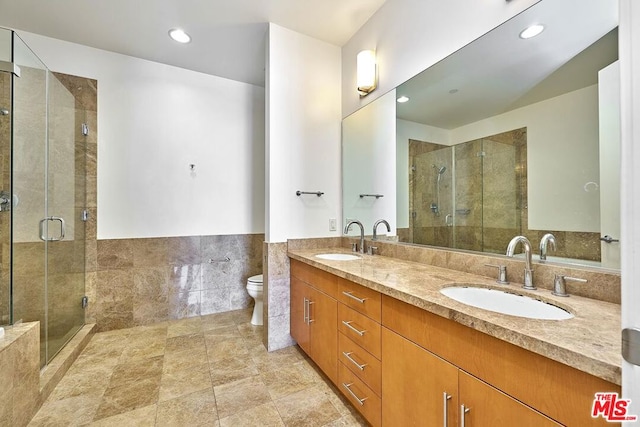 bathroom featuring vanity, toilet, and walk in shower