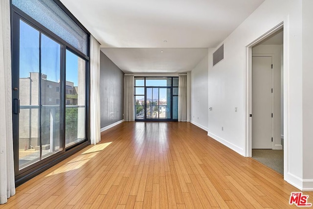 spare room featuring light wood-type flooring