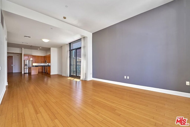 unfurnished living room featuring light hardwood / wood-style floors