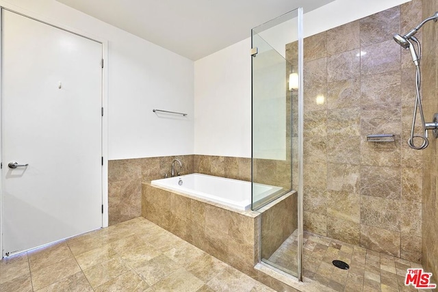 bathroom with shower with separate bathtub