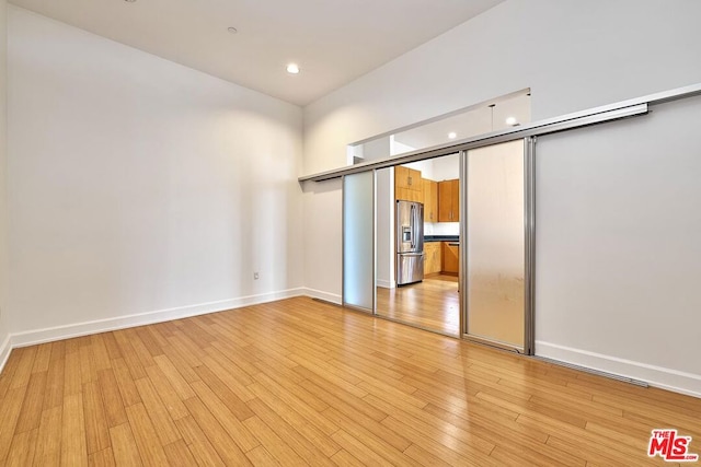 unfurnished room with light wood-type flooring