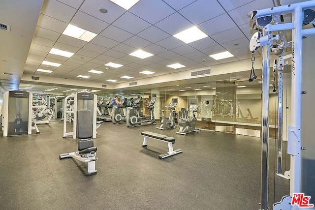 workout area featuring a drop ceiling