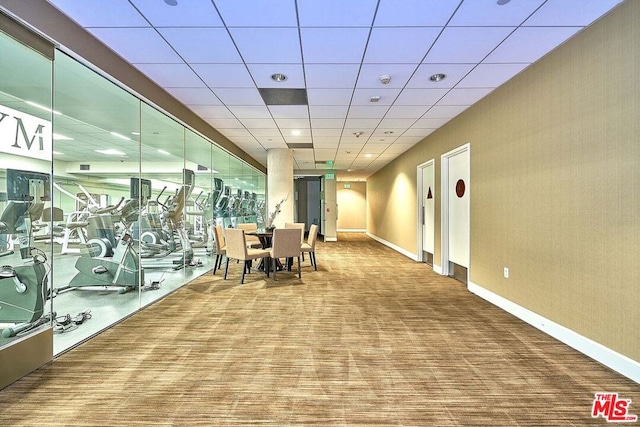 workout area featuring carpet flooring and a drop ceiling