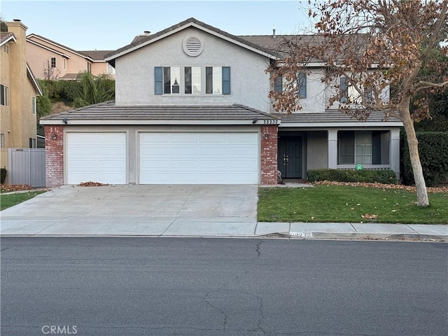 front facade featuring a garage and a front yard