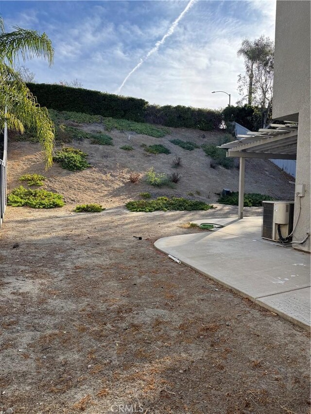 view of yard featuring a patio area and central air condition unit