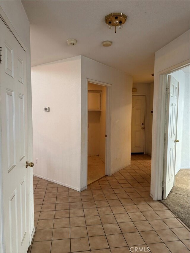 corridor with light tile patterned flooring