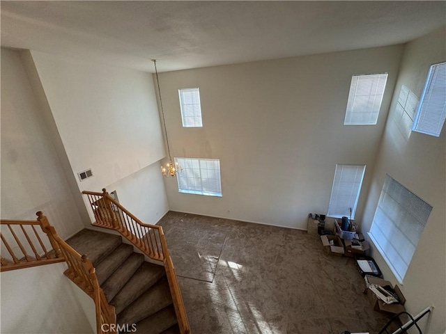 unfurnished living room with a notable chandelier