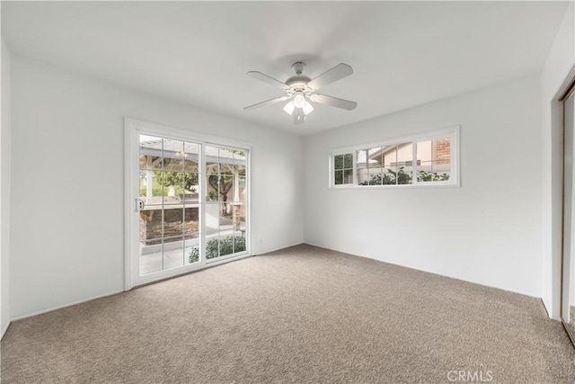 unfurnished room with ceiling fan, a healthy amount of sunlight, and carpet floors