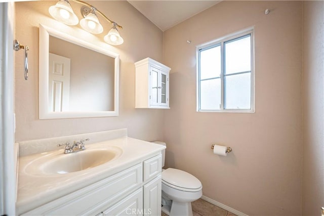 bathroom with tile patterned flooring, vanity, and toilet